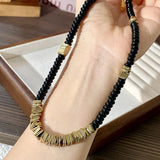 MAYTRENDS  -  High-end black disc beaded necklace for women with niche design metal splicing clavicle chain