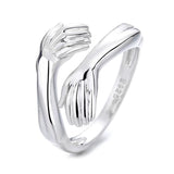 Maytrends Classic Creative Silver Color Hug Rings for Women Fashion Metal Carved Hands Open Ring Birthday Party Jewelry